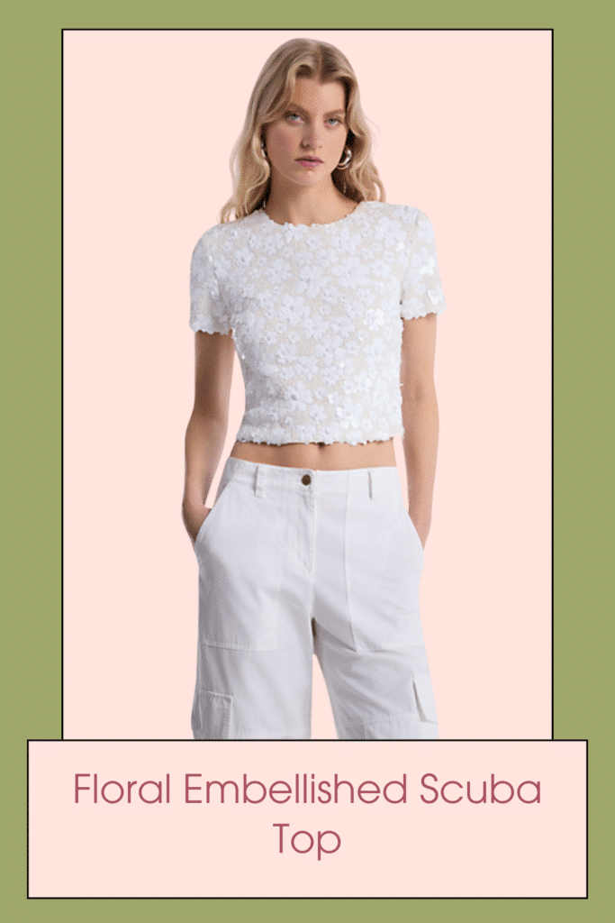 Playful and chic all at once, this top is not for a wallflower. It’s designed in a T-shirt inspired shape and features allover bead-and-sequin embellishments that creates a 3-D l floral pattern. Temper the cropped fit with mid-rise pants.
