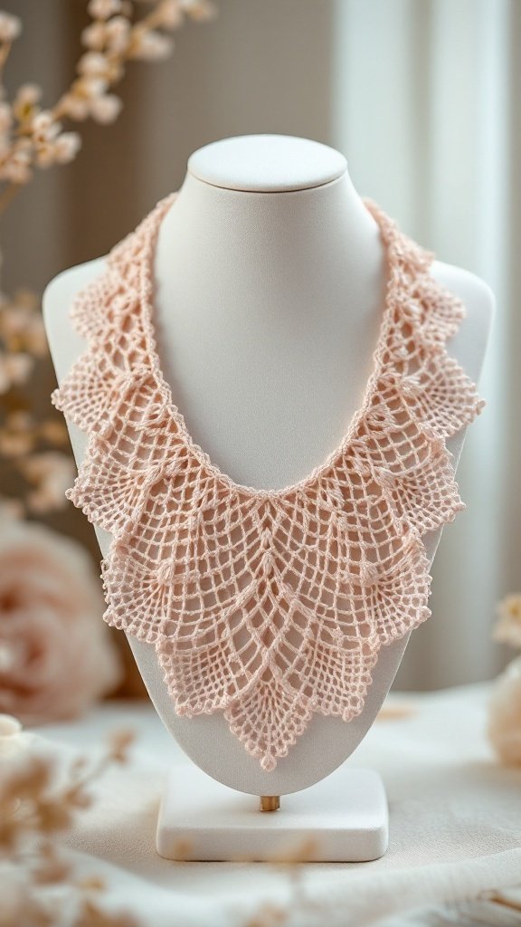 A delicate pink crochet necklace displayed on a stand, featuring a lace pattern.
